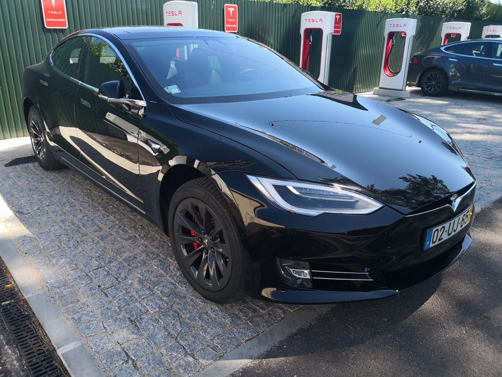 Tesla frente a frente com um carro da polícia. Uma corrida